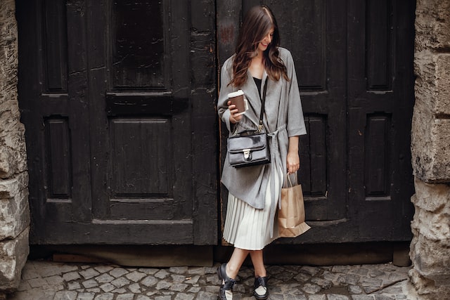 a girl with a black small bag over her shoulder