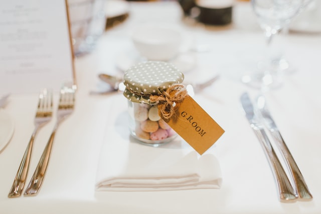 a jar of sweets with an inscription for the groom