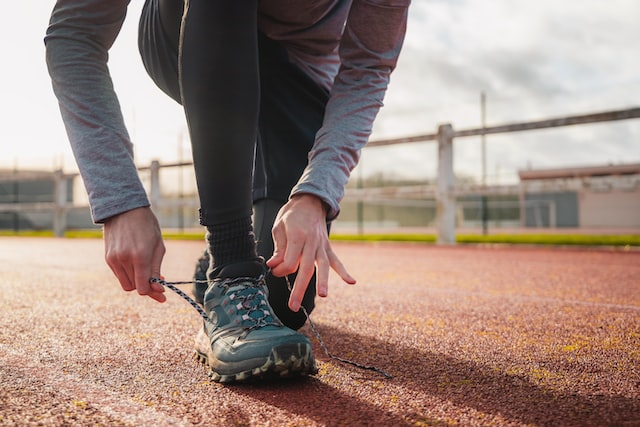 a person tying a shoelace