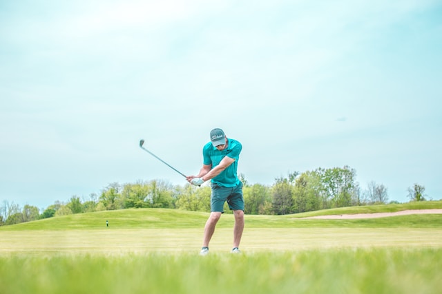 person in green golf clothes playing in golf