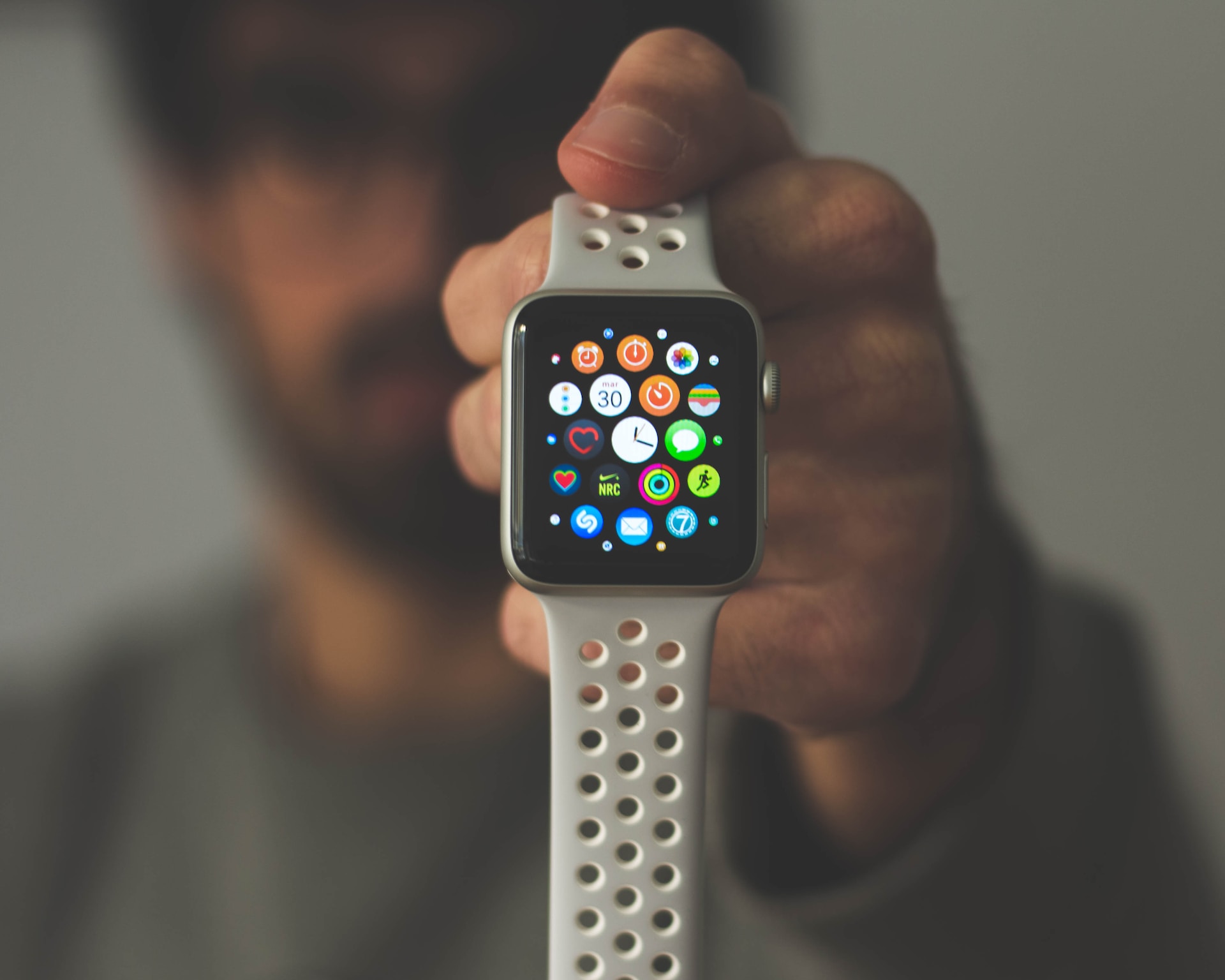 person holding apple watch