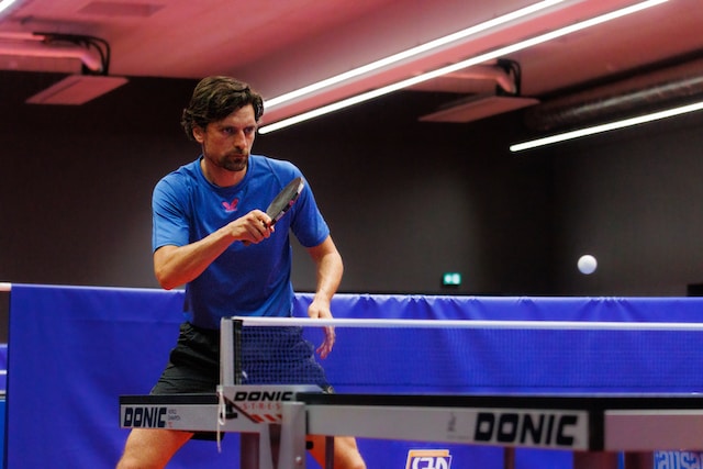 person in uniform playing ping pong