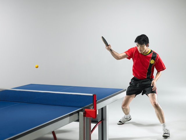 person playing table tennis