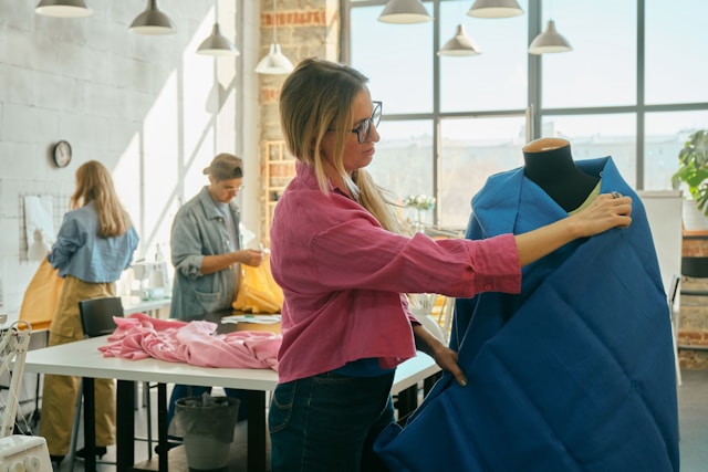 a-woman-is-working-on-a-dress-on-a-mannequin