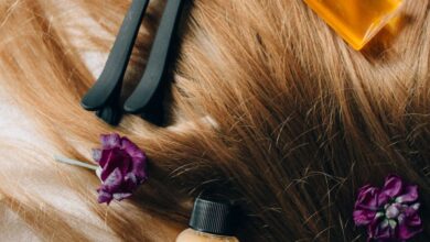 Hair Styling Tools - Aesthetic flatlay of hair care items and flowers against a soft background.