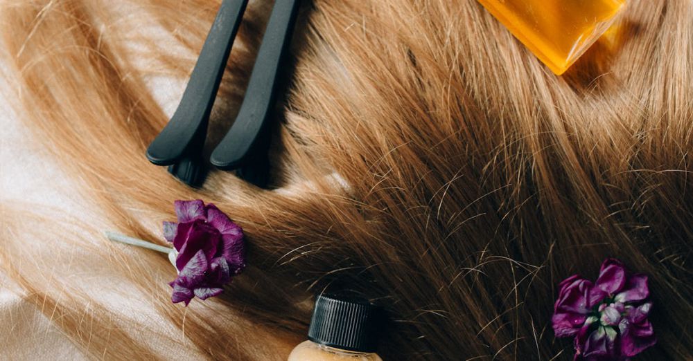 Hair Styling Tools - Aesthetic flatlay of hair care items and flowers against a soft background.