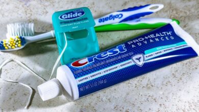 Teeth Whitening Products - Close-up of dental care items including toothbrush, floss, and toothpaste for oral hygiene.