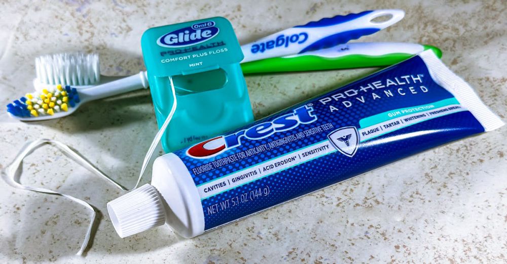 Teeth Whitening Products - Close-up of dental care items including toothbrush, floss, and toothpaste for oral hygiene.