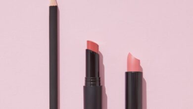 Lip Care Products - Elegant display of pink lipsticks and pencil on a soft pink background, ideal for beauty and cosmetics.