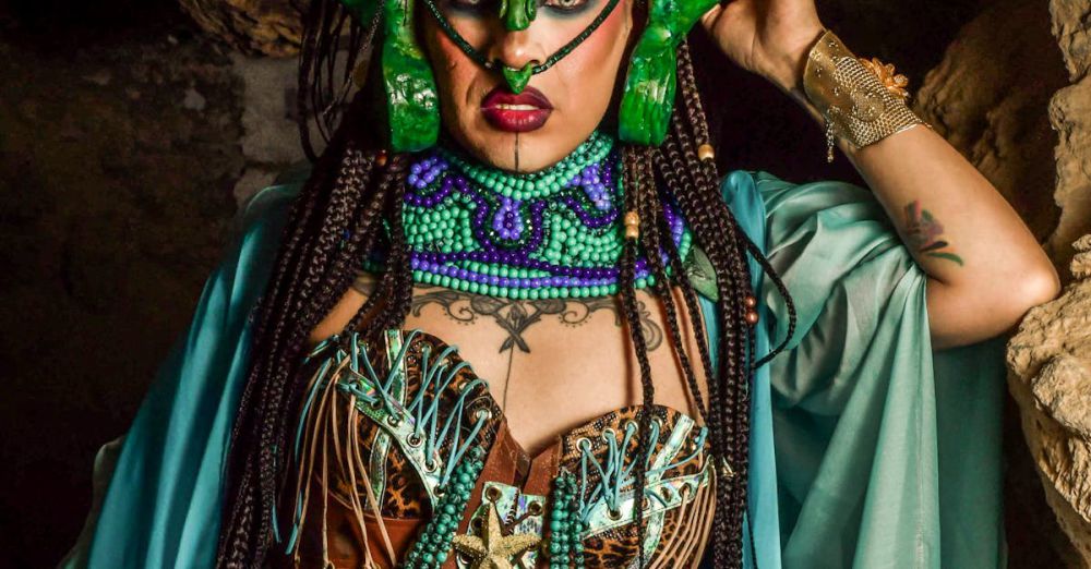 Makeup Sets - A vibrant artistic costume portrait photographed in a cave setting.