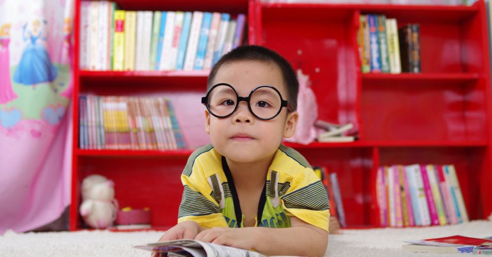 Kids’ Books - Boy Standing Near Bookshelf