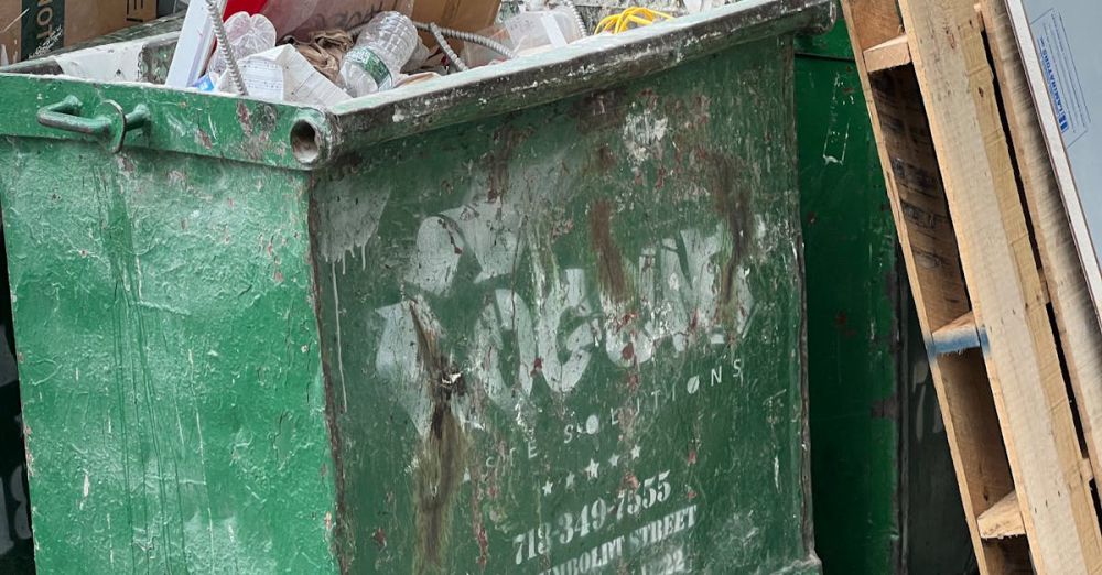 Litter Boxes - A green trash can with cardboard boxes in it