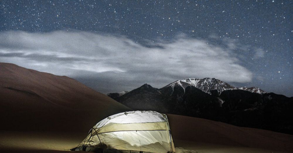 Sleeping Bag - A glowing tent under a starry night sky in a serene desert landscape.