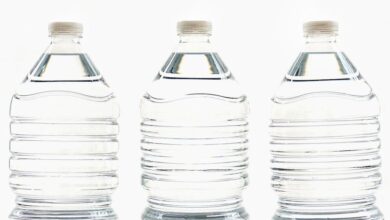 Water Bottles - Three clear plastic bottles filled with water, standing side by side.