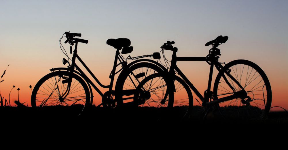 Bicycles - Two bicycles silhouetted against a colorful sunset sky, highlighting outdoor adventure.