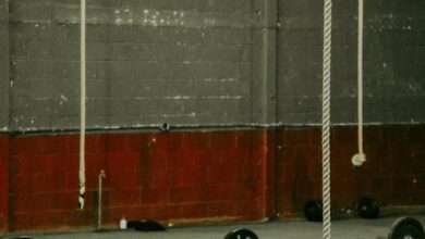 CrossFit Equipment - Spacious industrial gym with barbells and ropes, perfect for crossfit and weightlifting exercises.