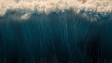 Outdoor Drones - Stunning aerial capture of ocean waves crashing and creating a mesmerizing water pattern.