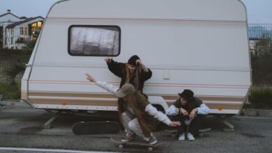 Sports Hats - Young skateboarders enjoying an evening by a trailer, showcasing street culture and fashion.