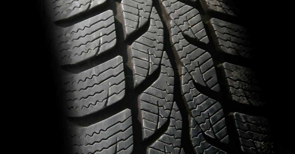 Tires - Detailed close-up image of a rubber tire showcasing texture and tread pattern, ideal for design concepts.