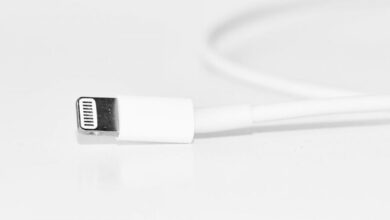 Charger - Minimalist close-up of a white charging cable, useful for tech themes.