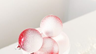 Dryer Balls - Glass bowl with red ornament balls and snowy decor on a white background.