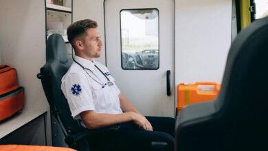 Zero-Waste Kits - A paramedic in uniform sits inside an ambulance, reflecting on a dispatch.