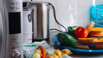 Home Appliances - A modern home kitchen counter displaying fresh vegetables and appliances, ideal for healthy cooking.