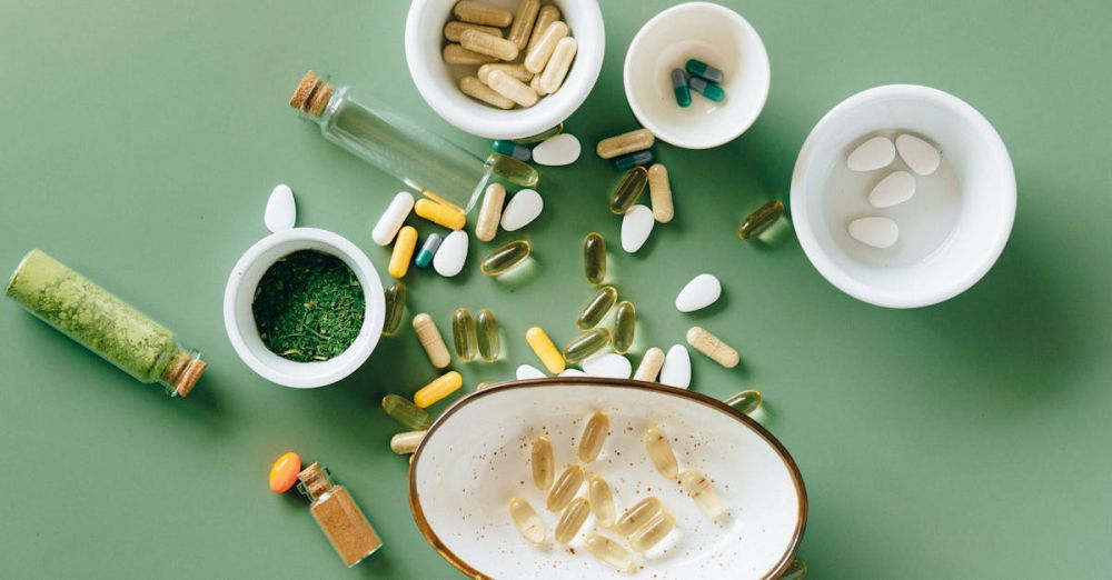 Health Supplements - Top view of various herbal and pharmaceutical supplements in ceramic bowls on a green background.