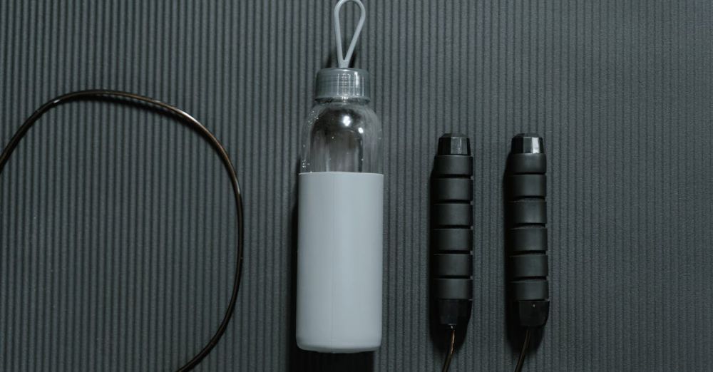 Home Gym Essentials - Flatlay of a water bottle and jump rope on a yoga mat, highlighting fitness essentials.