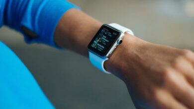 Fitness Tracker - Focus on a smartwatch worn on an adult's wrist, showcasing its digital display.
