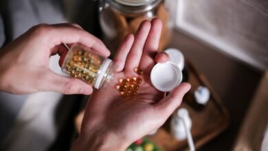 Immune Support Supplements - Hands carefully holding supplement capsules, representing health and wellness.