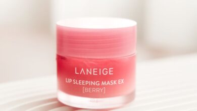 Skincare Routine - Close-up of Laneige Lip Sleeping Mask EX in berry flavor on textured surface. Product photography.