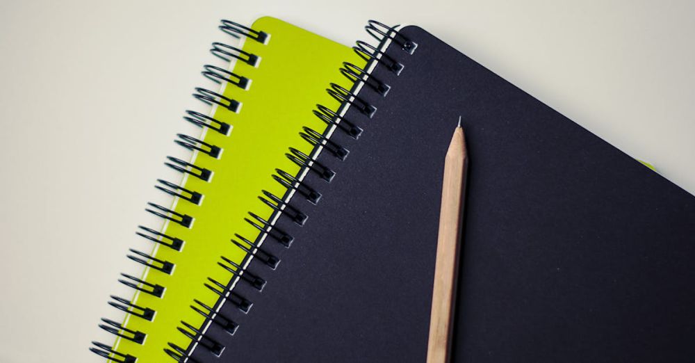 Notebooks - Close-up of spiral-bound notebooks with a pencil, perfect for creative projects.