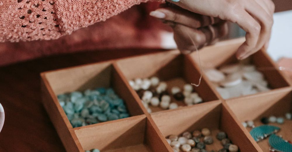 Jewelry Organizers - Hands crafting bracelets with colorful beads and a wooden organizer.