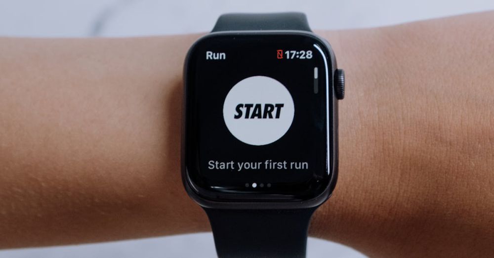 Fitness Watches - Close-up of a smartwatch showing a running app on a marble background.