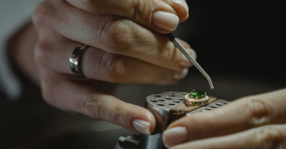 Engraving Products - Close-up of a jeweler skillfully crafting an emerald ring, showcasing precision and detail.