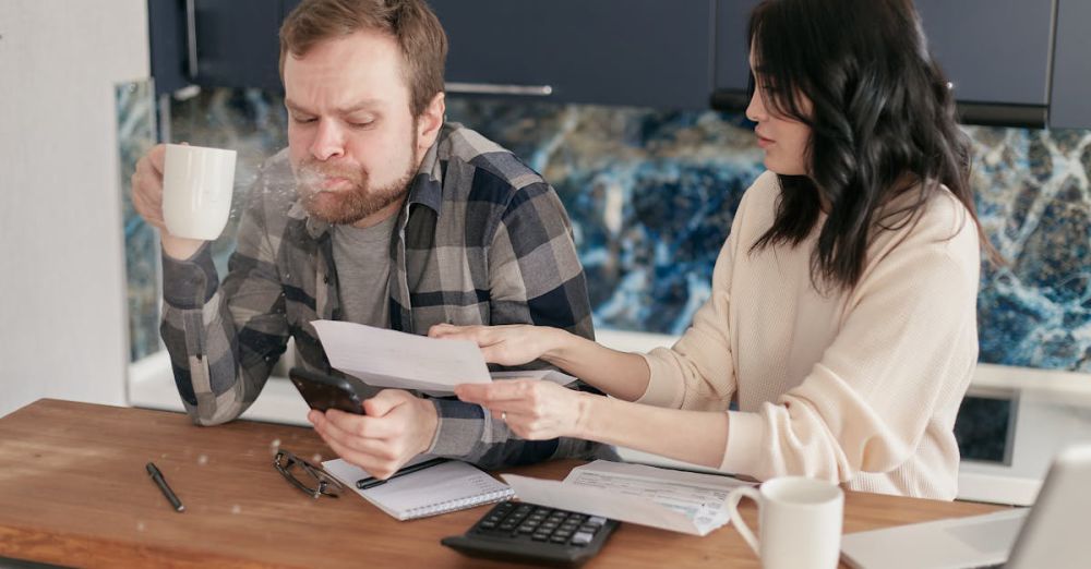 Stress Gadgets - Couple discussing financial documents and budgeting at a kitchen table.