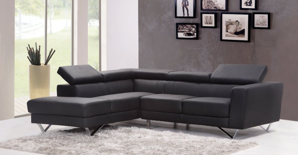 Furniture - Contemporary living room featuring a sleek black sectional sofa and chic wall art.