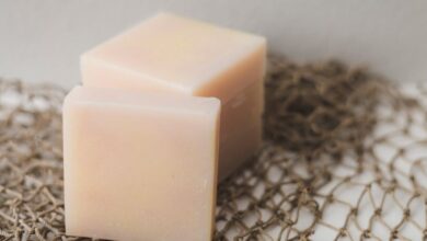 Soaps - Two bars of natural handmade soap placed on a rustic netting backdrop, perfect for a spa theme.