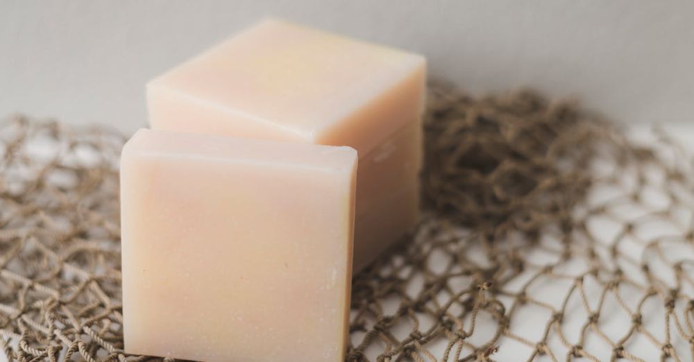 Soaps - Two bars of natural handmade soap placed on a rustic netting backdrop, perfect for a spa theme.