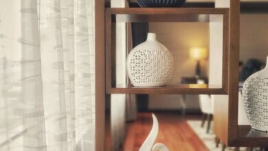Vases - Elegant hotel room with modern decor featuring decorative shelves and luxury vases for a chic ambiance.