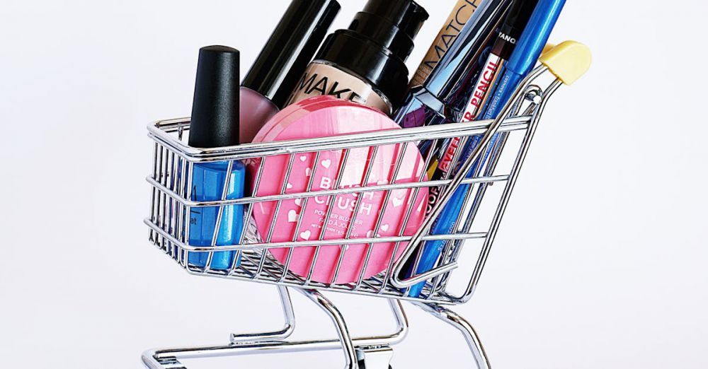 Products - Miniature shopping cart filled with a variety of cosmetics on a white background.