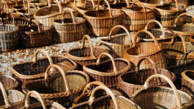 Baskets - Assorted handmade wicker baskets displayed in an outdoor market setting.