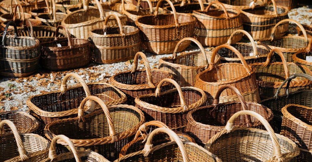 Baskets - Assorted handmade wicker baskets displayed in an outdoor market setting.