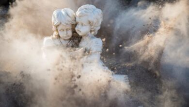 Statues - Intricate stone statues engulfed in a dynamic dust explosion, creating a dramatic artistic effect.