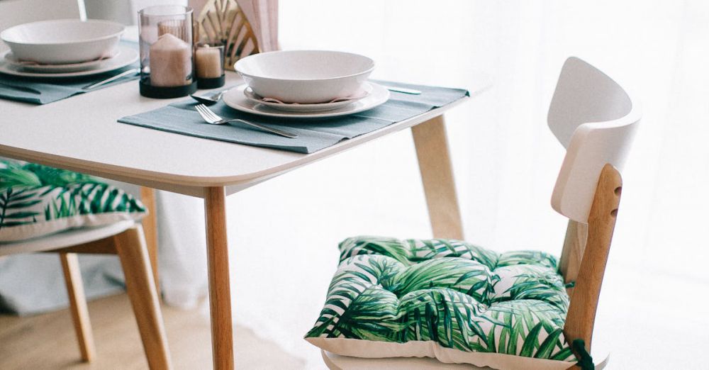 Placemats - Contemporary dining room with wooden furniture and green-leaf cushions. Bright and inviting.