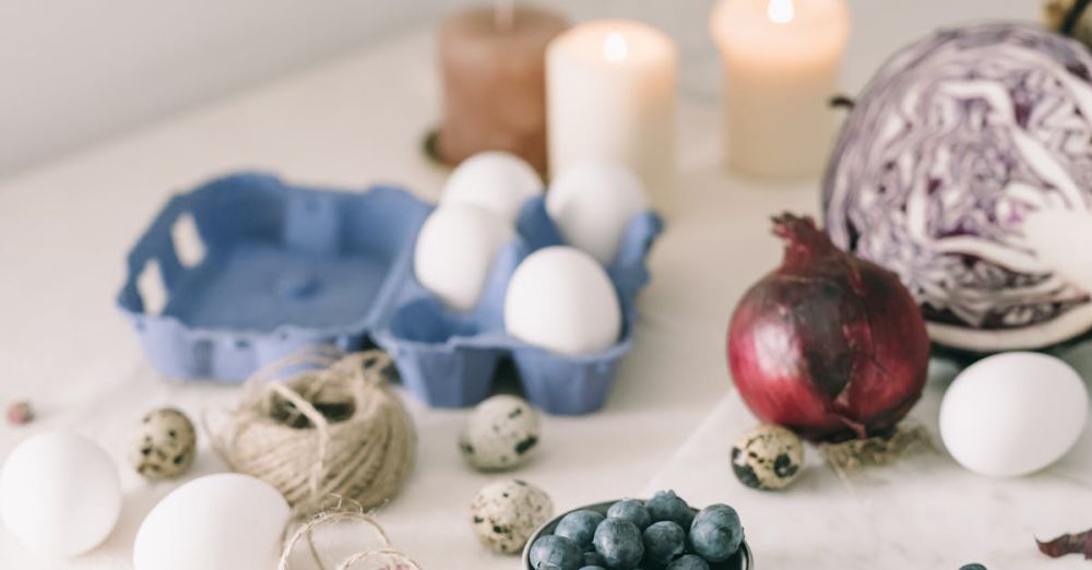 Aromatherapy Candles - Artistic still life of eggs, blueberries, onion, and candles on a table.