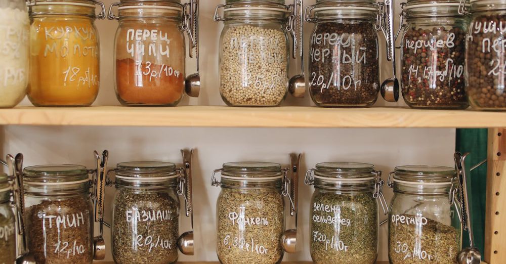 Food Storage - Glass jars filled with various spices and ingredients on wooden shelves promoting zero waste lifestyle.