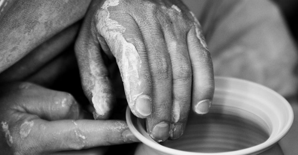 Pottery - Artistic black and white close-up of hands shaping clay pottery on a wheel.