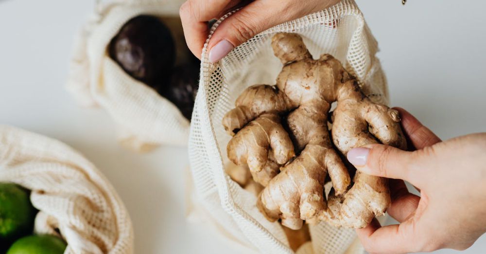 Produce Bags - Hands placing ginger into an eco-friendly reusable net bag on a kitchen counter.